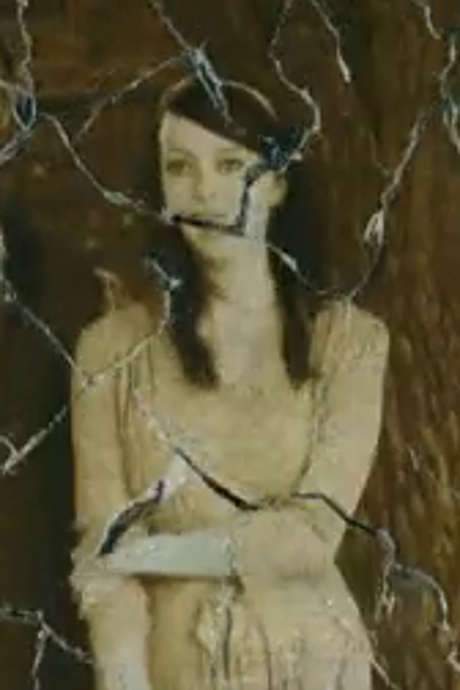   The body of a young woman is slowly consumed by insects.  